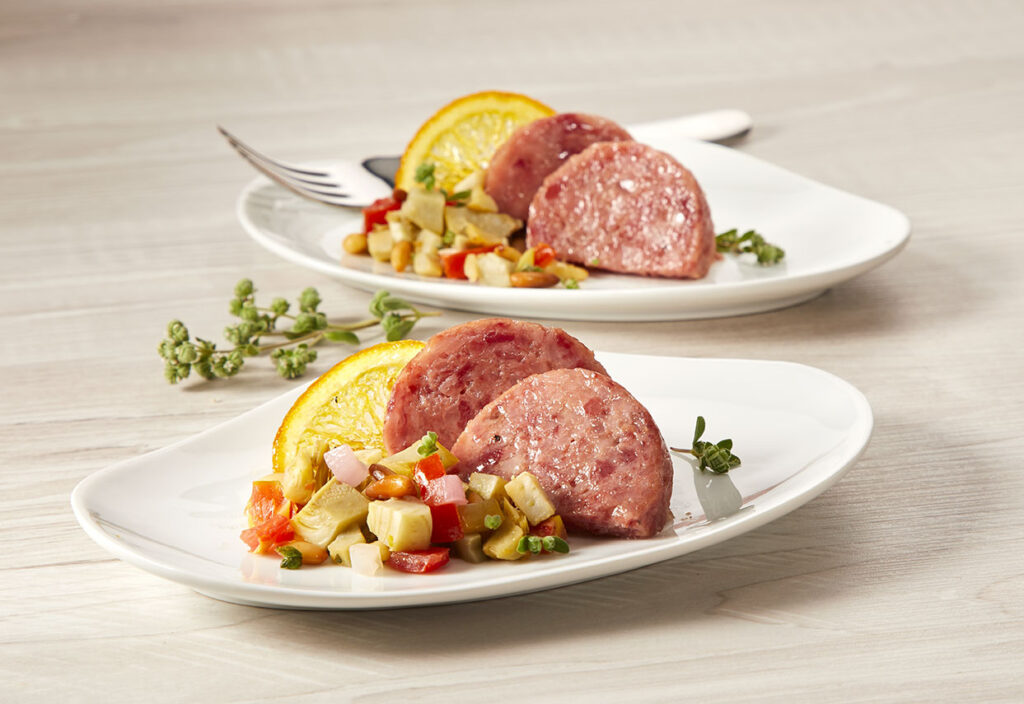 Cotechino con caponata di carciofi e arancia candita